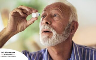 An older man uses eye drops as part of a good care routine to maintain his vision health.